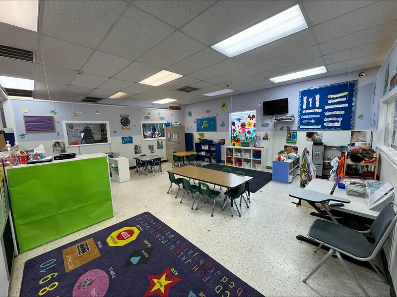 After-school classroom with tables, chairs, and activity shelves