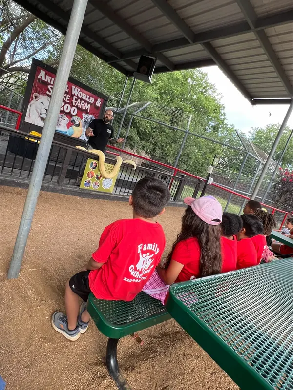 Summer campers gathered at picnic tables at the zoo